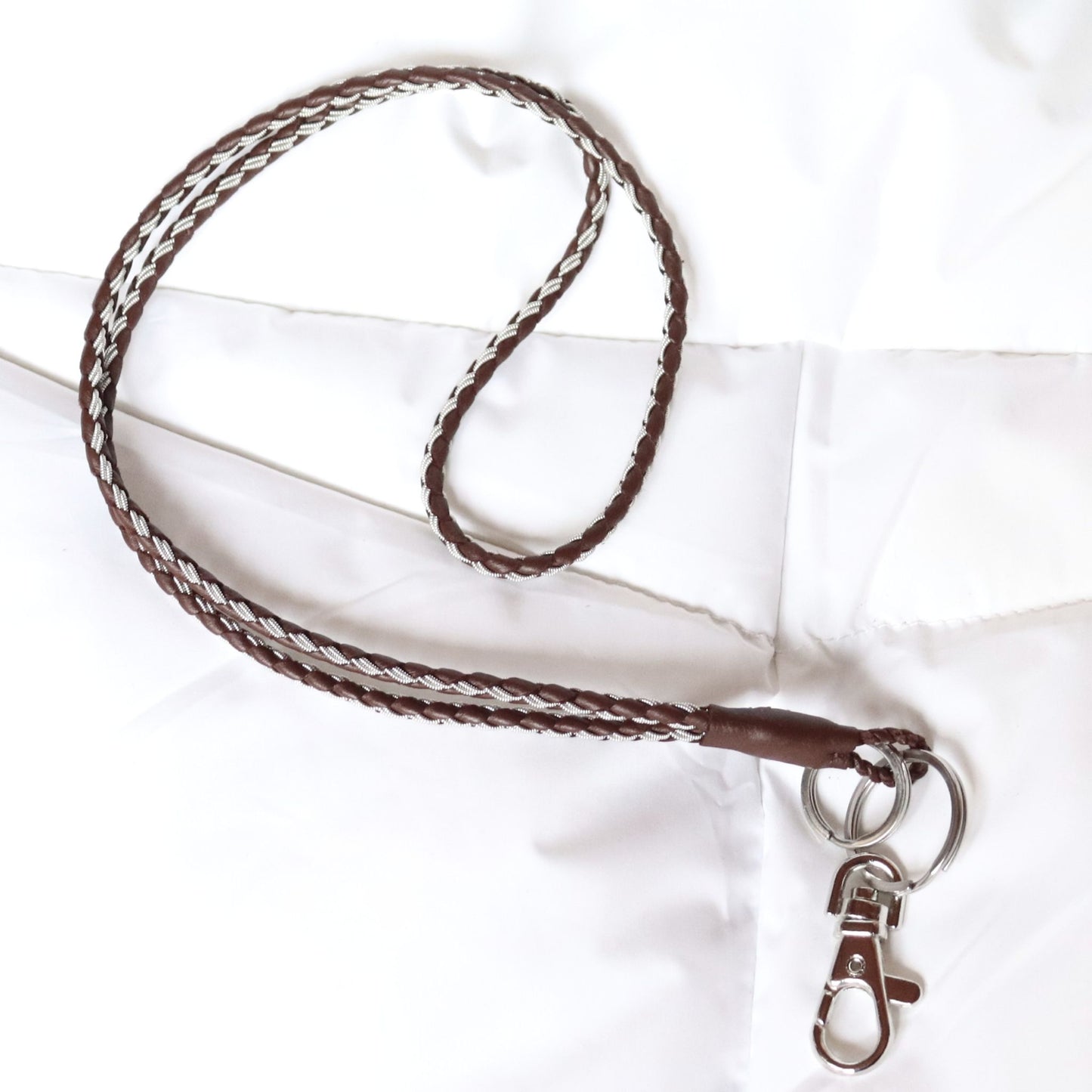 Handcrafted Sami lanyard in brown leather with pewter braid, featuring a hook and key rings