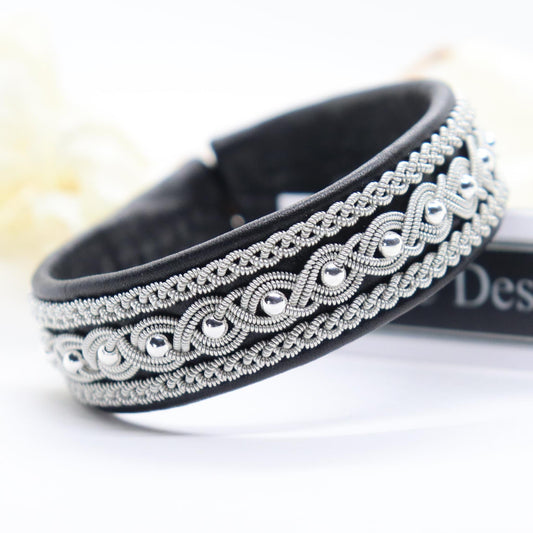 Handcrafted Sami bracelet made from reindeer leather with pewter braids and silver beads.