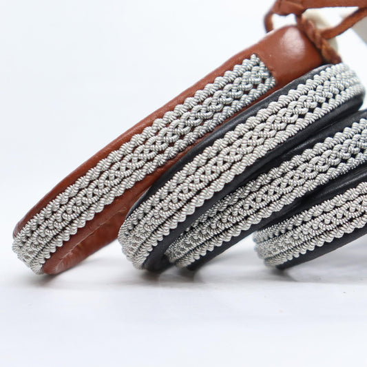 Handcrafted Sami leather bracelets with braided pewter thread shown in a close-up