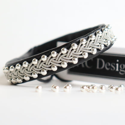 Silver beads braided into a black sami bracelet