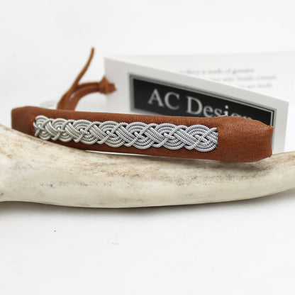 Sami leather hair barrette with decorative pewter braid. 