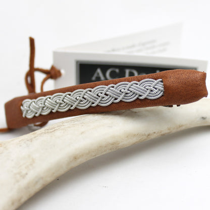 Sami leather hair clip with decorative pewter braid. 