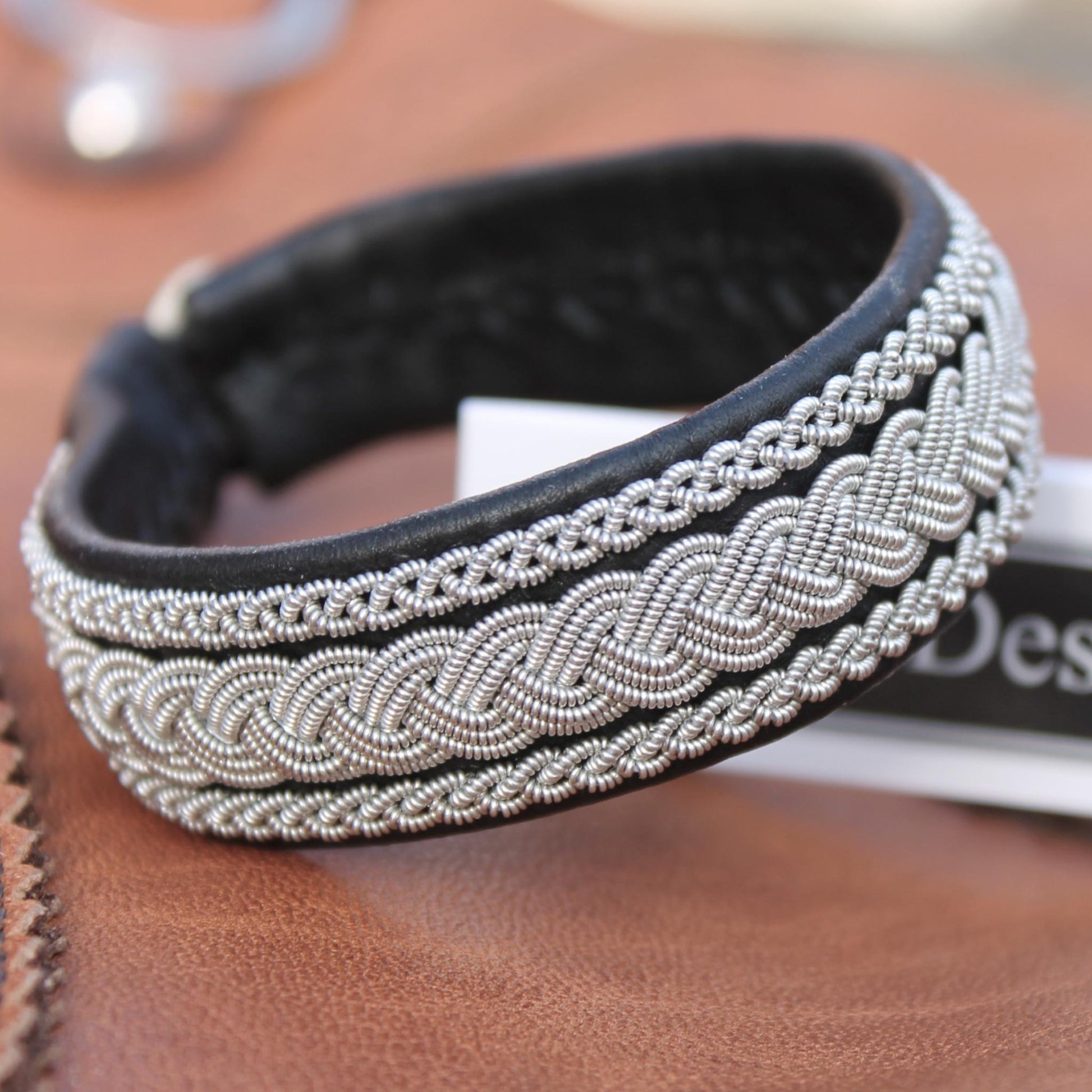 Handcrafted black Sami bracelet made from soft leather and braided pewter thread