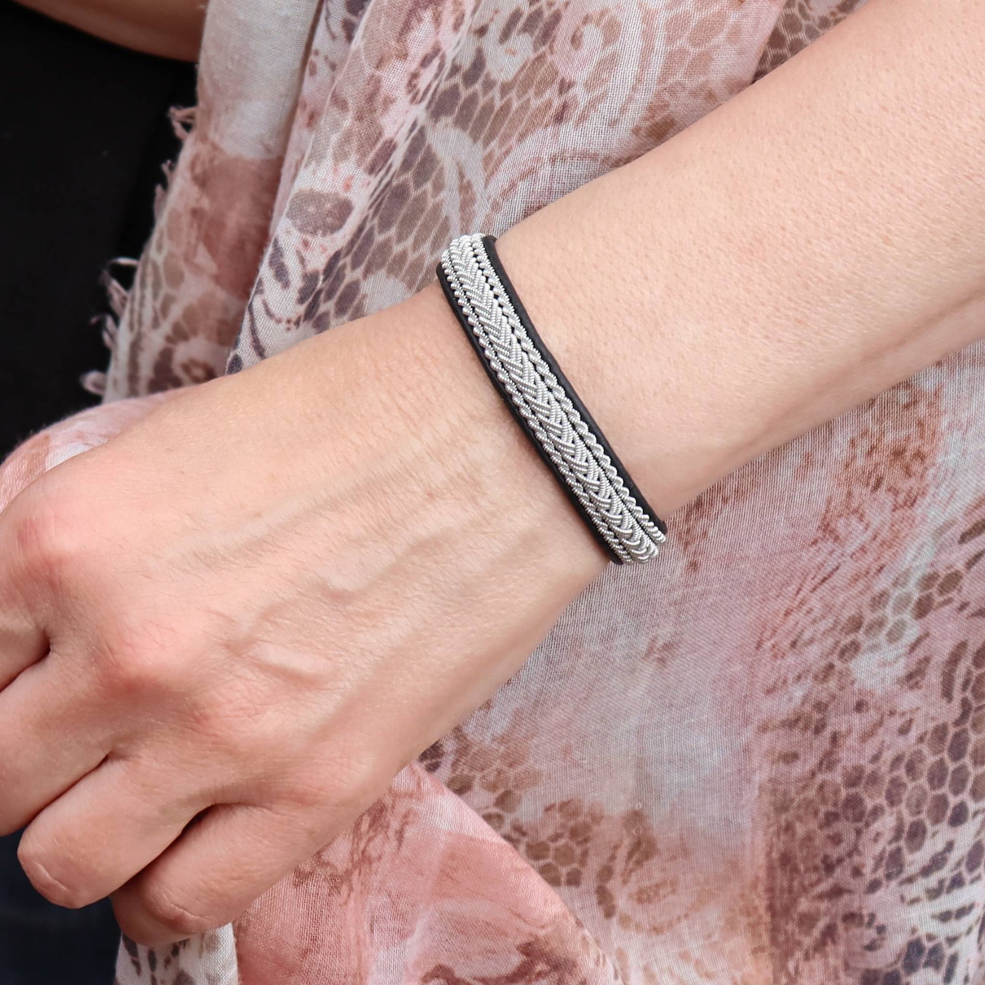 Black Sami bracelet worn on a womans wrist