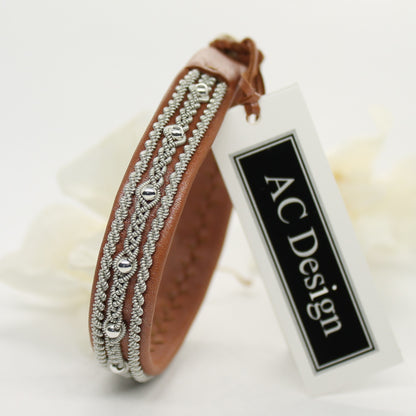  Sami bracelet made from reindeer leather with braided pewter wire and decorative silver beads