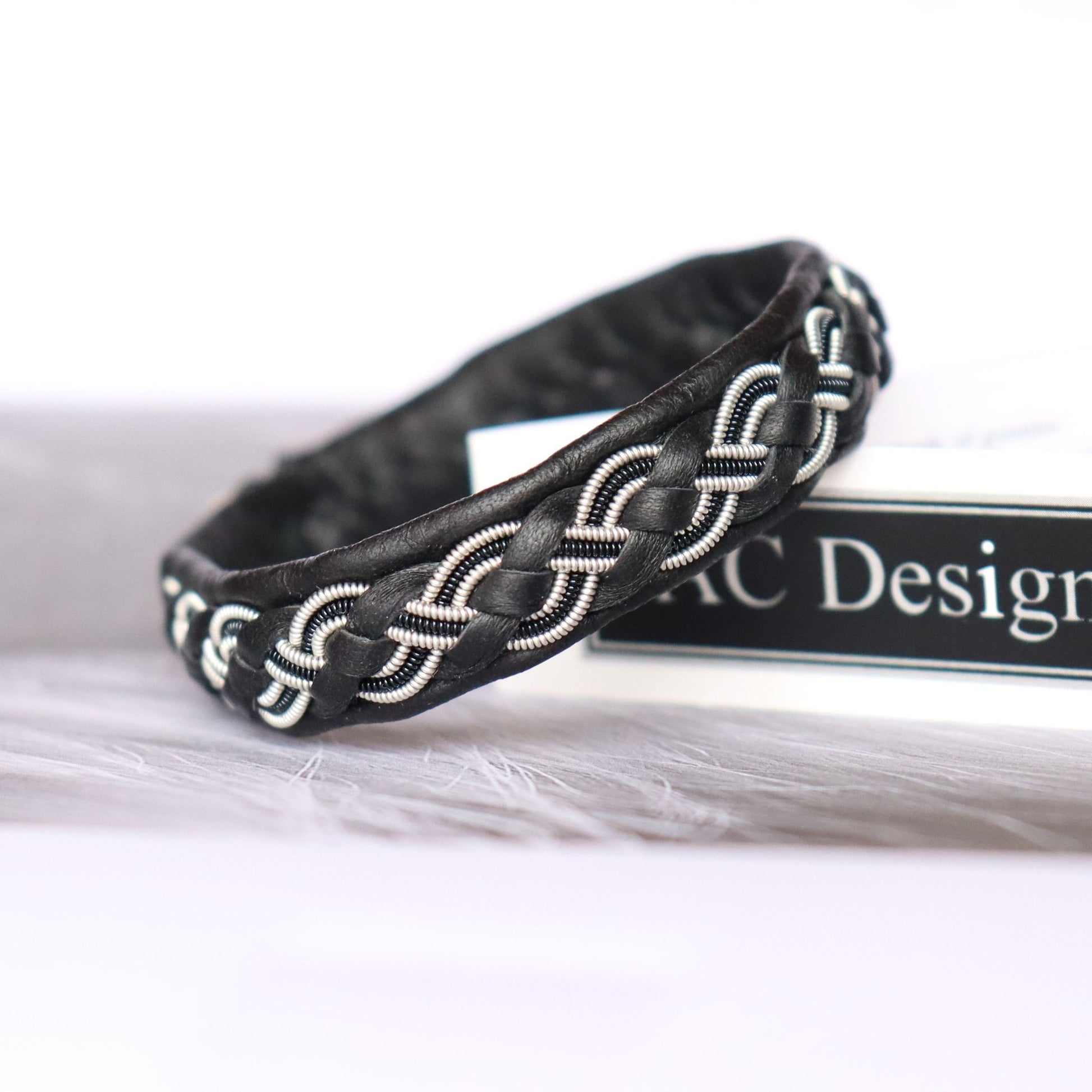 Handcrafted Sami bracelet with a braid combining pewter thread and decorative black copper wire
