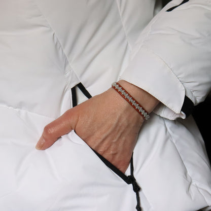 Slim nature brown Sami bracelet with pewter braid and silver beads worn on wrist.