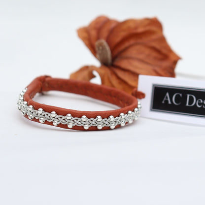 Narrow Sami leather bracelet with braided pewter thread and tiny silver beads