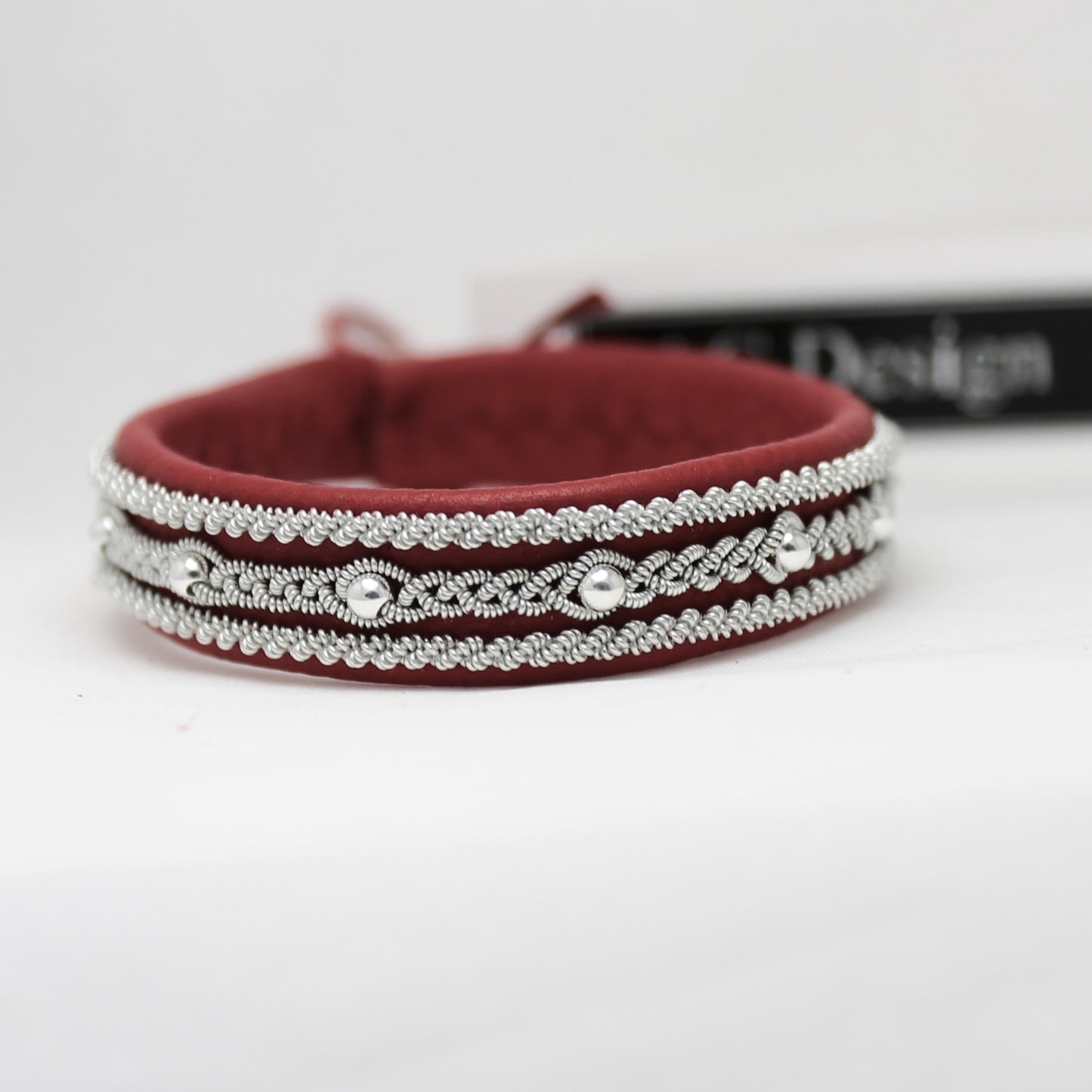 Sami bracelet made from red reindeer leather with braided pewter wire and silver beads