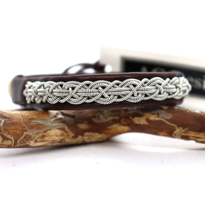 Slim Sámi leather bracelet with braided pewter wire, shown in a close-up.