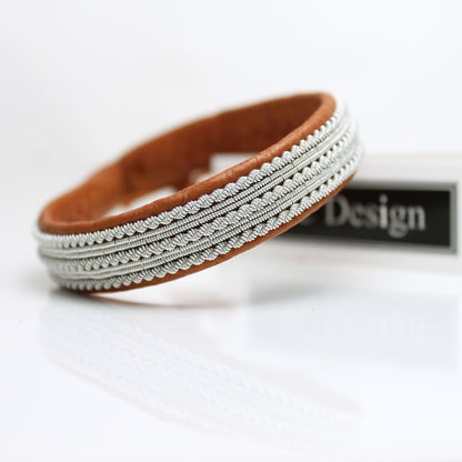Sami bracelet in reindeer leather and pewter thread.