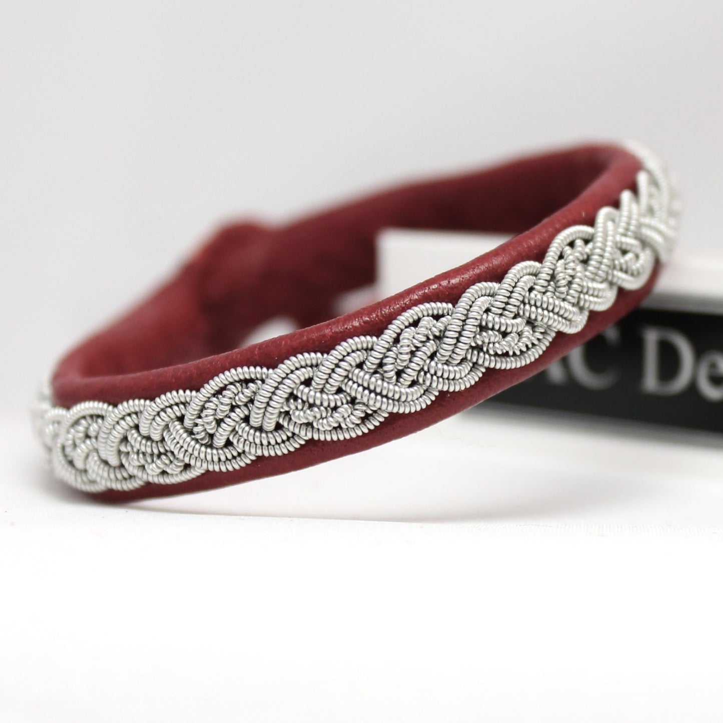 Handmade sami bracelet in red reindeer leather and pewter braid