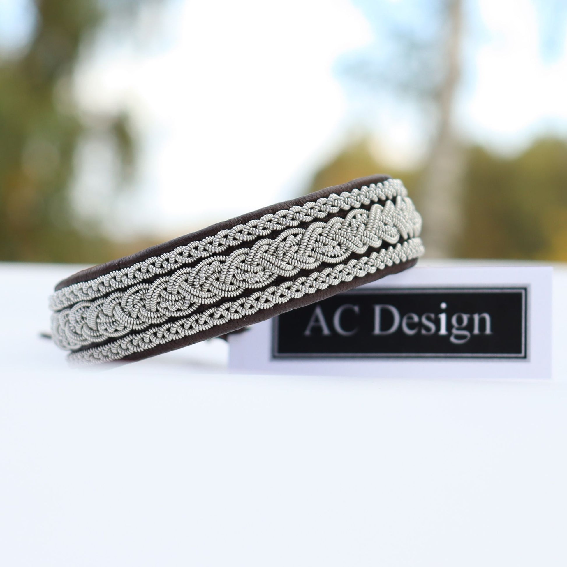 Handmade swedish leather jewelry shown i snow