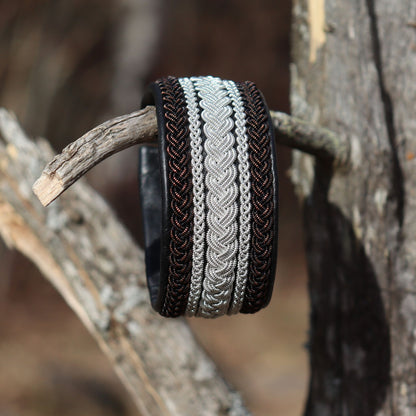 Wide leather Sami bracelet with pewter and copper‑shimmering black copper braids