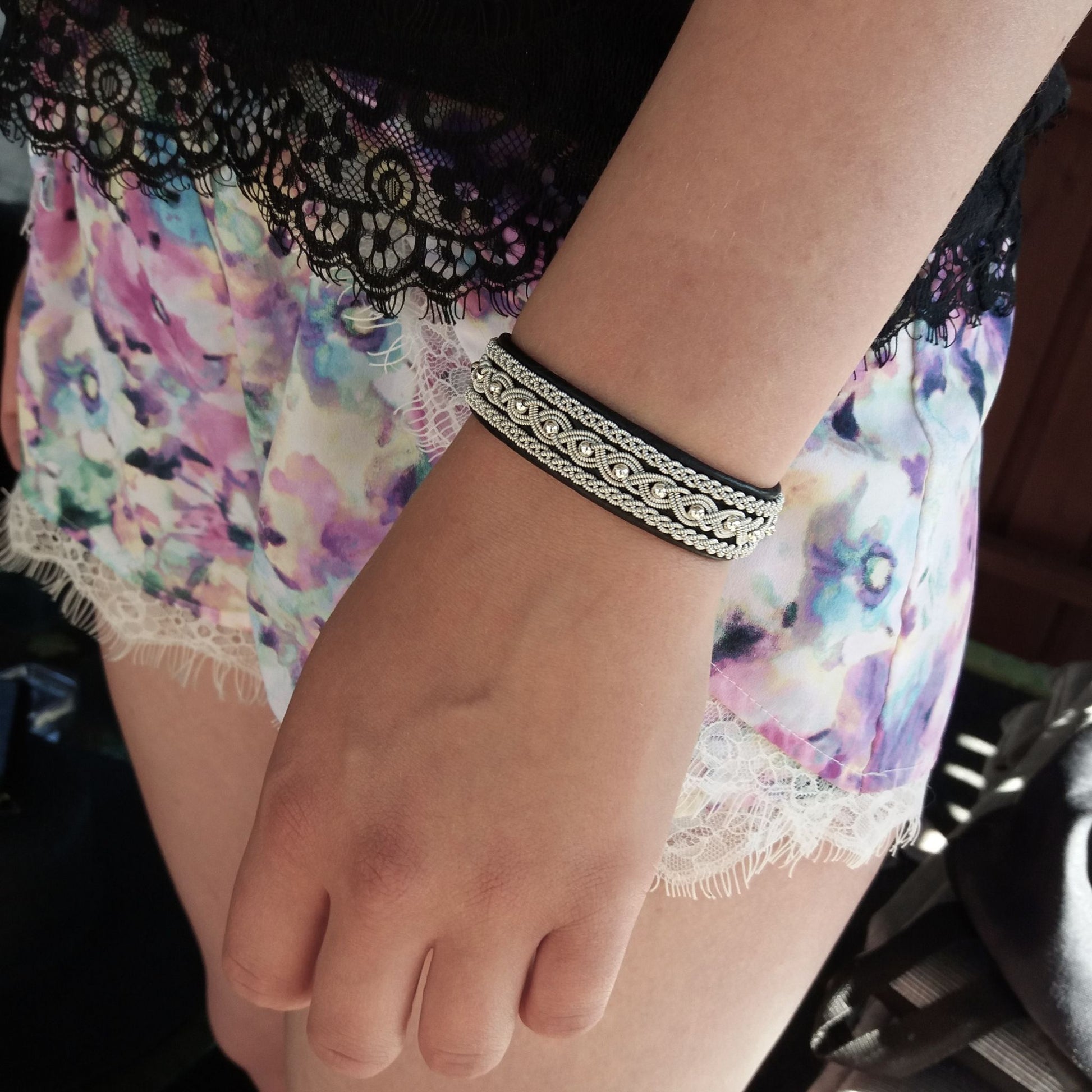 Sami bracelet with silver beads worn on wrist