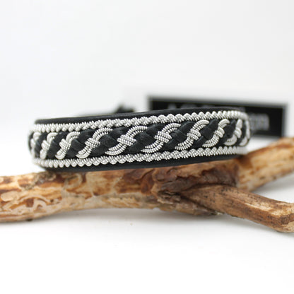 Black Sami bracelet showing a pewter braid combined with leather thread braided as part of the decorative pattern