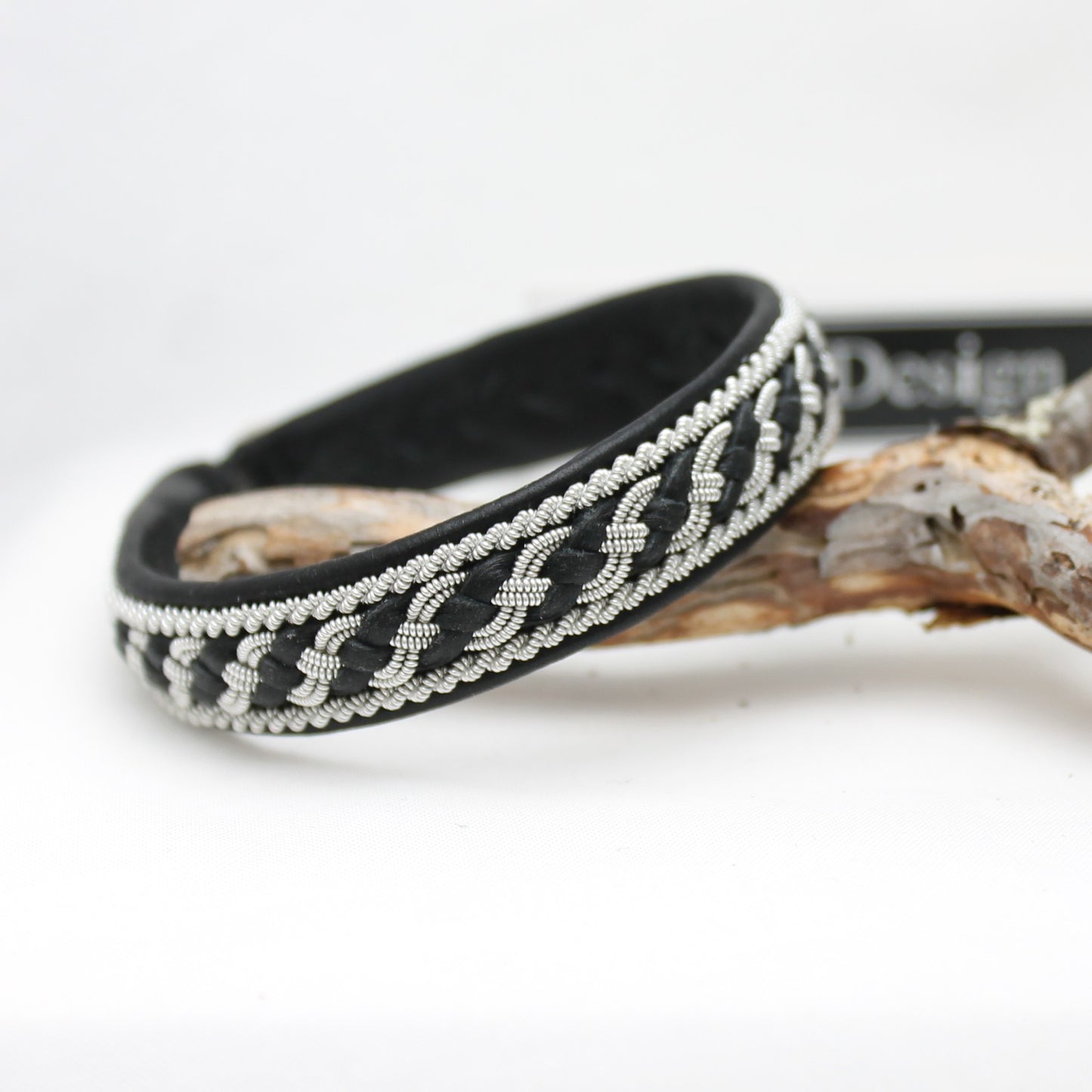 Sami style bracelet showing a tin braid combined with leather thread braided as part of the decorative pattern