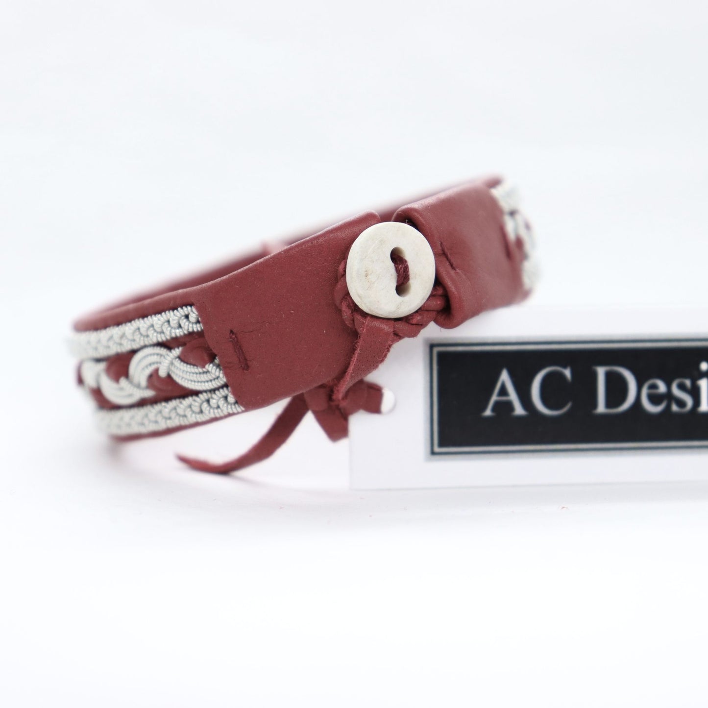 Sami leather bracelet with braided pewter thread and visible reindeer antler button