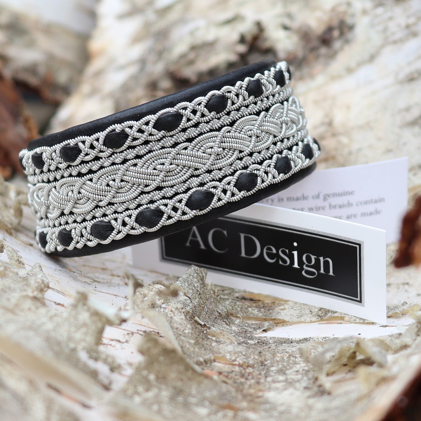 Sami bracelet cuff style in black leather, rest on AC Design label