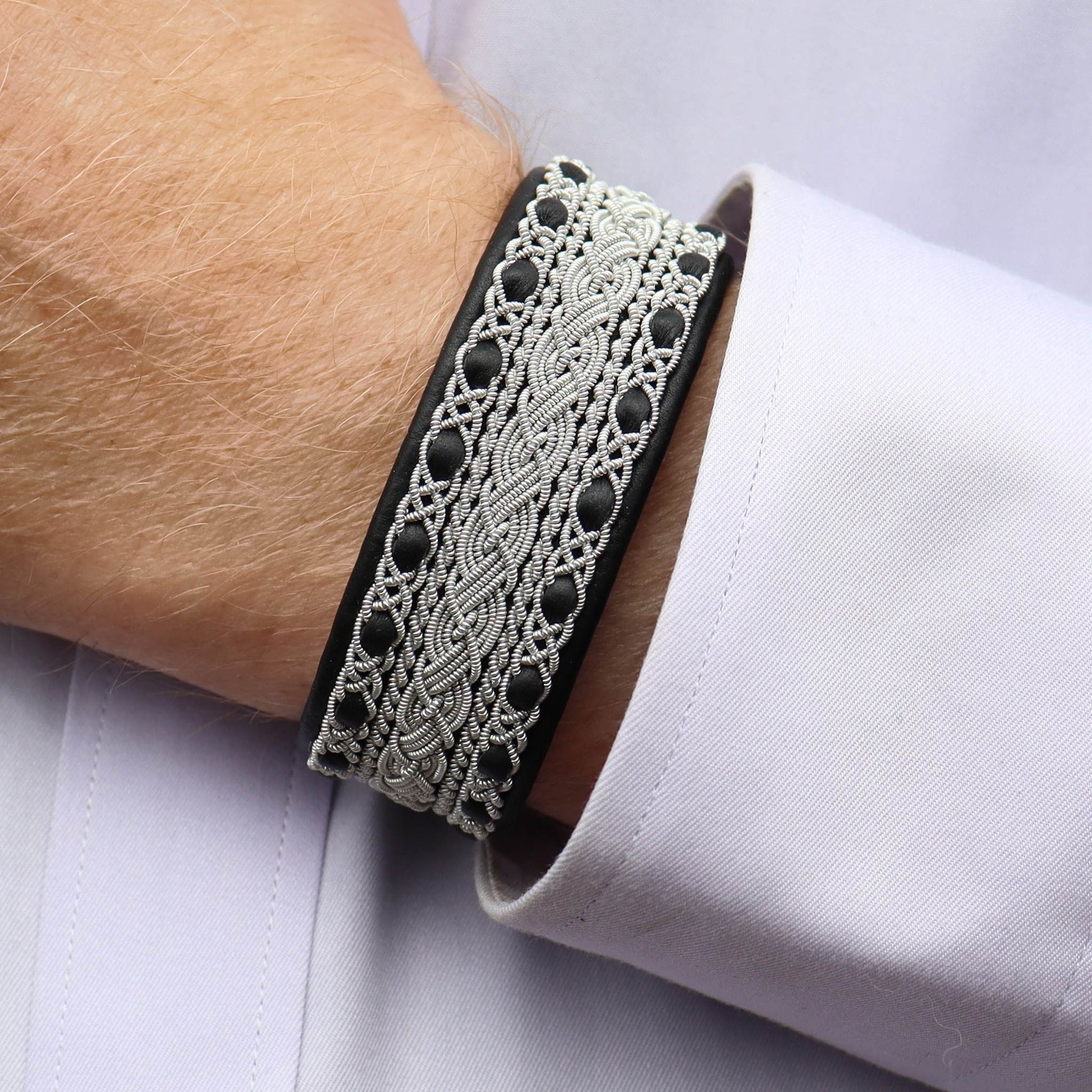Sami bracelet cuff style in black leather, worn on wrist
