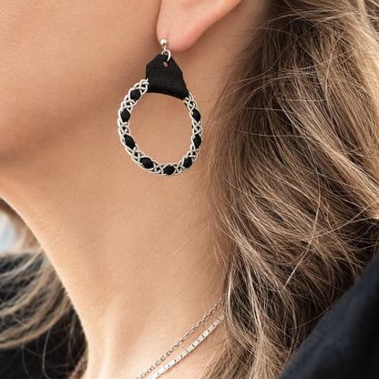Sami earrings in Black reindeer leather worn in the ear.