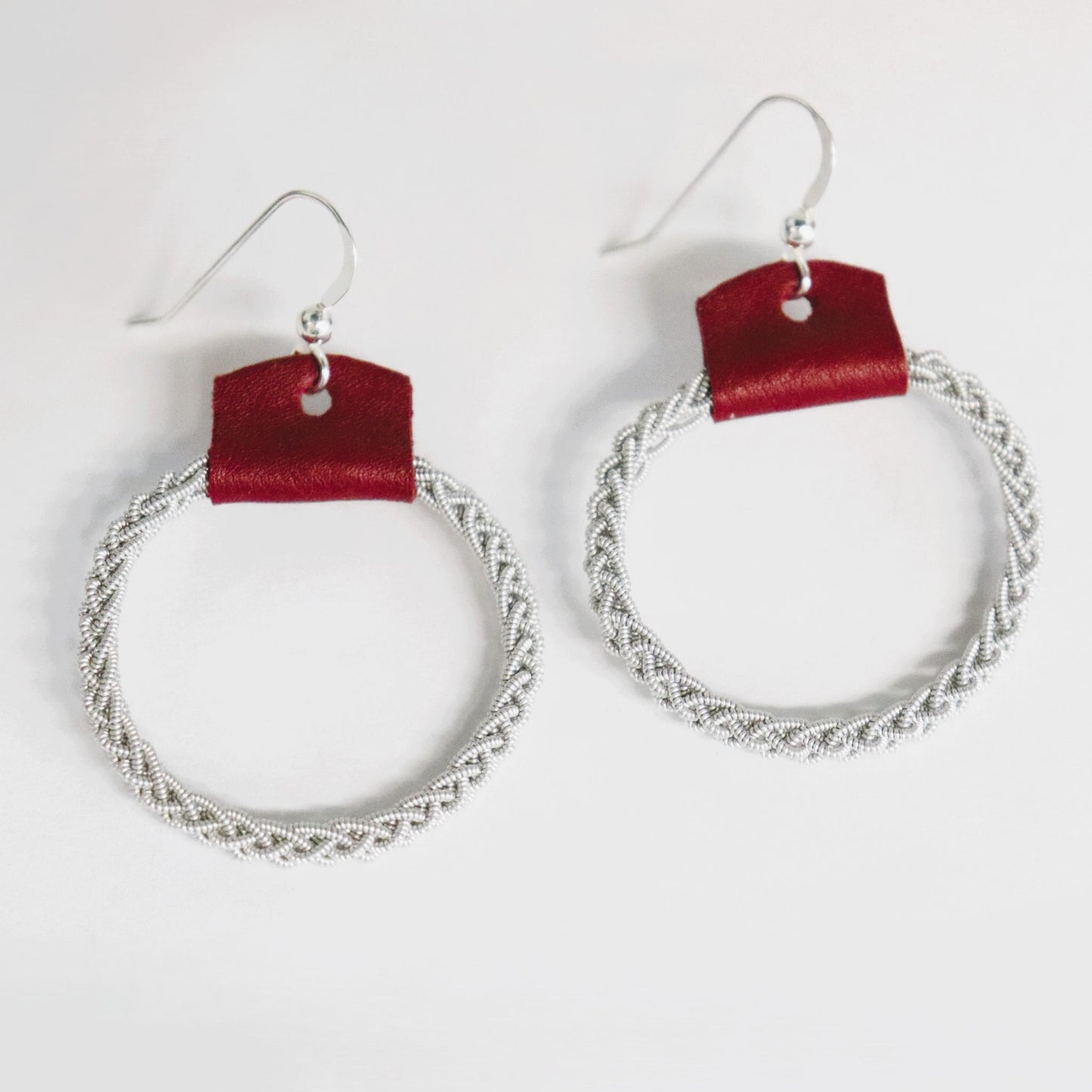 A pair of Sami leather and pewter wire earrings with sterling silver hooks