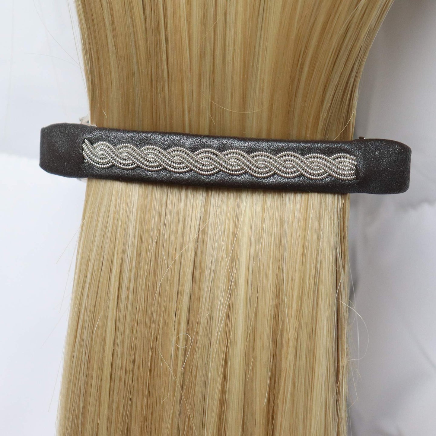 Swedish handcrafted Sami hair clip in reindeer leather with pewter braid, worn in hair