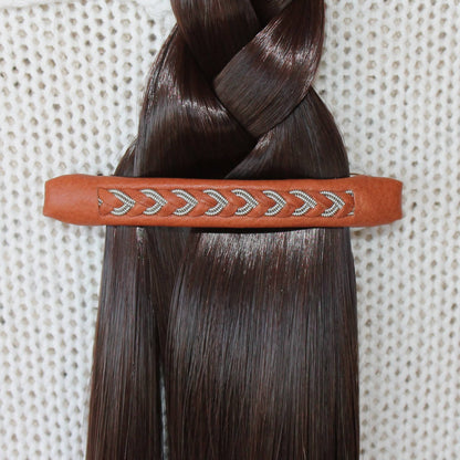 Handvrafted Sami hair clip used to secure a braid