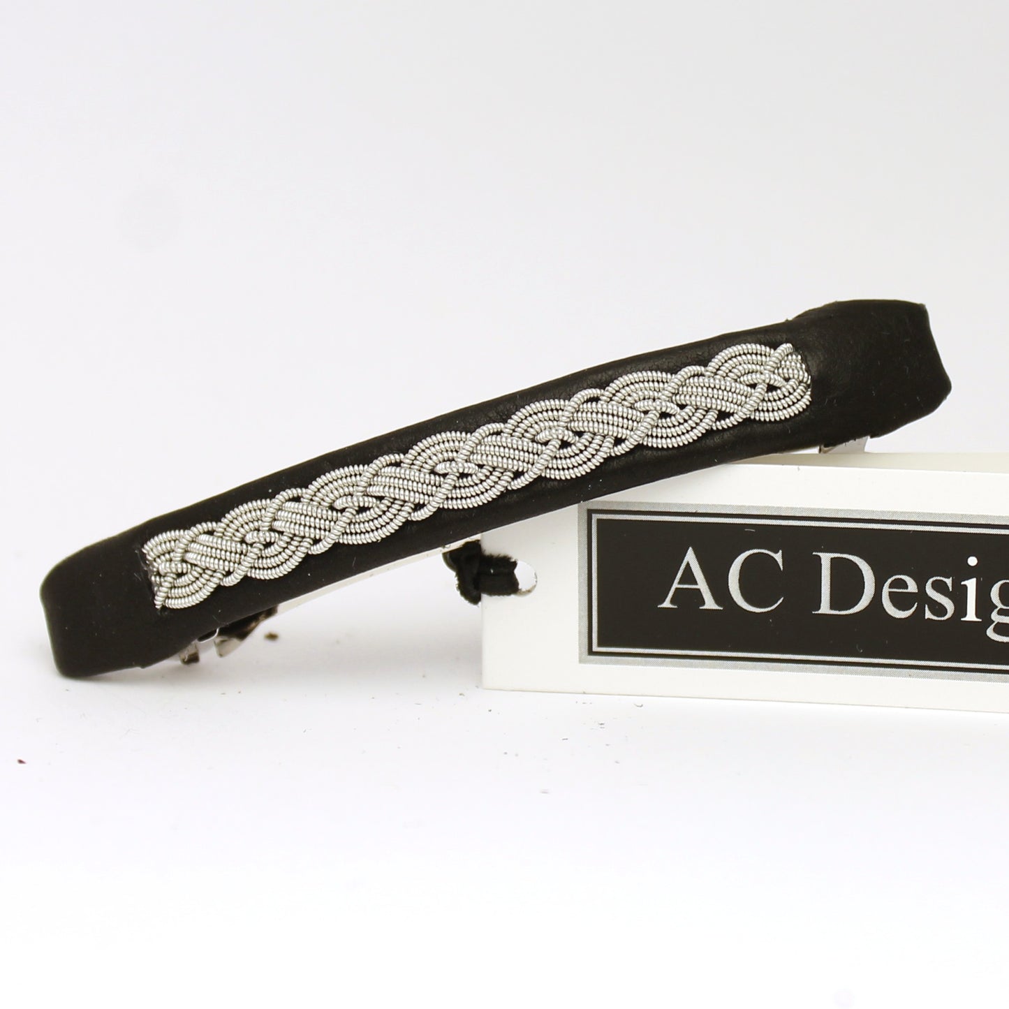 Handmade Sami hair barrette made from black leather and pewter wire.