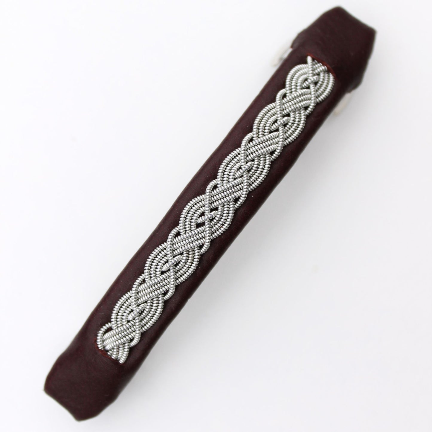 Handcrafted Sami style hair clip made from reindeer leather and pewter thread.