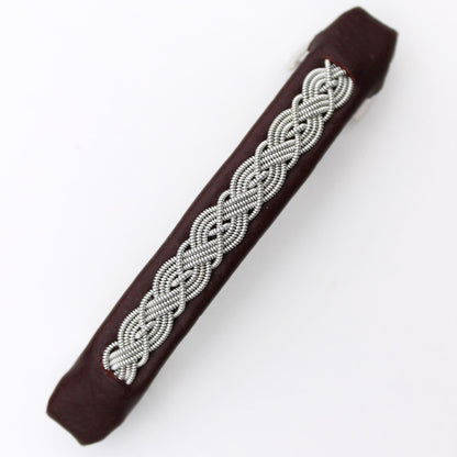 Handcrafted Sami style hair clip made from reindeer leather and pewter thread.