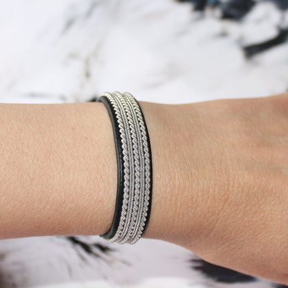 Sami bracelet in leather and pewter thread worn on wrist