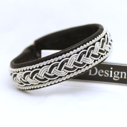Handcrafted black Sami bracelet with braided pewter thread and decorative leather cord
