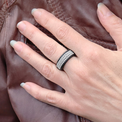 Sami ring in black leather with pewter braids, worn on finger
