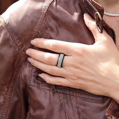 Sami pewter ring in leather with pewter braids, worn on finger