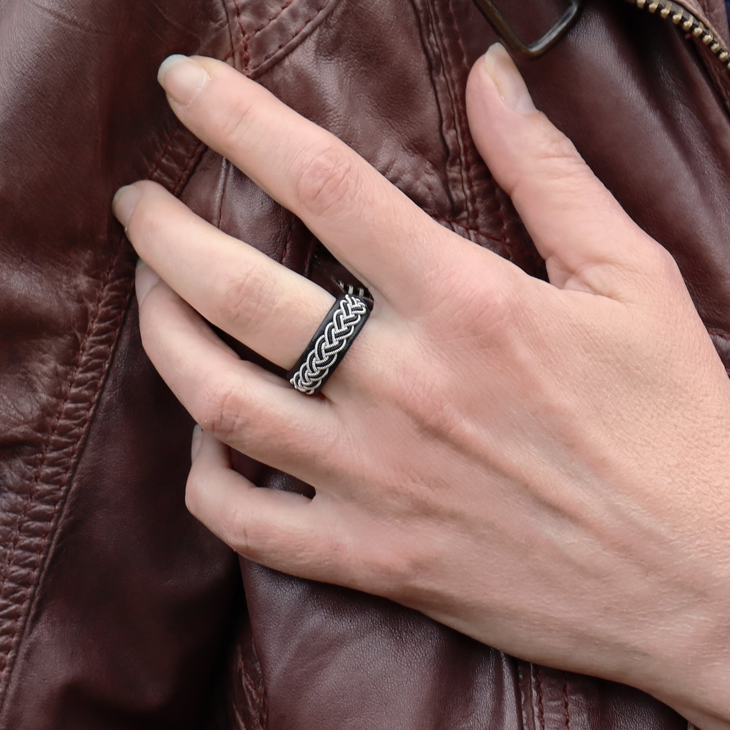 Sami ring in black leather with pewter braid, worn on finger