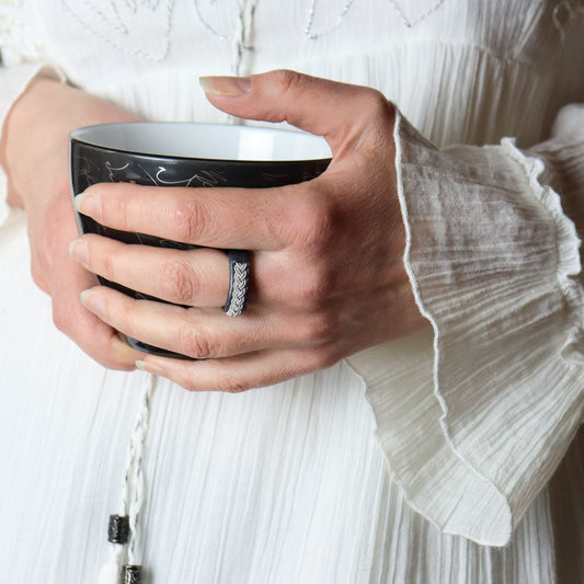 Sami ring in black leather and pewter, worn on finger