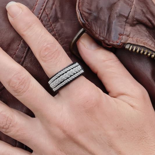 Sami ring in black leather and pewter, worn on finger