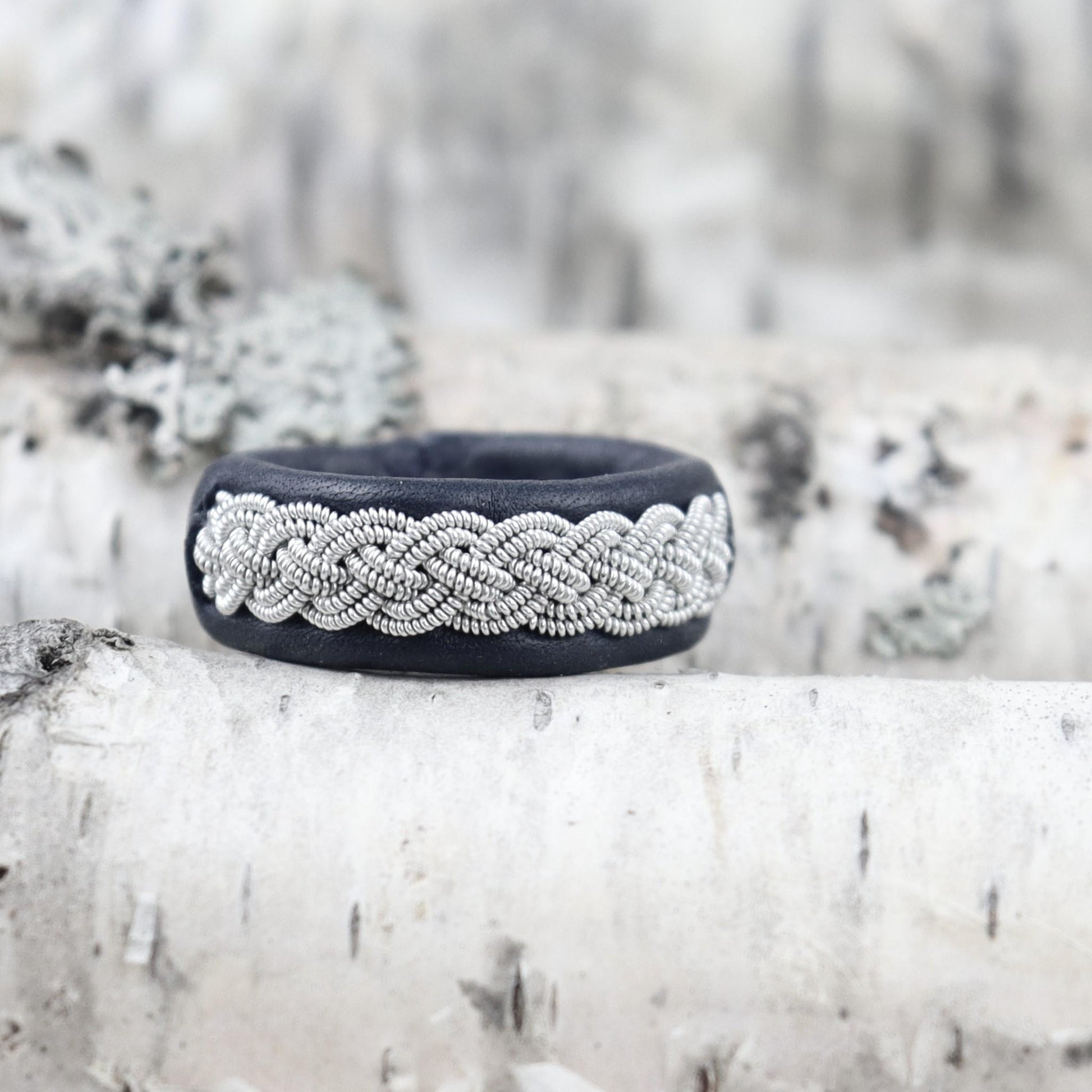 Sami ring on birch wood