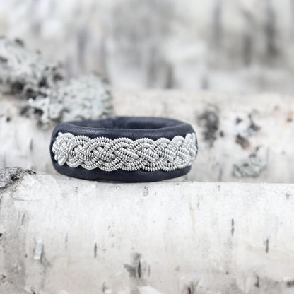 Sami ring on birch wood