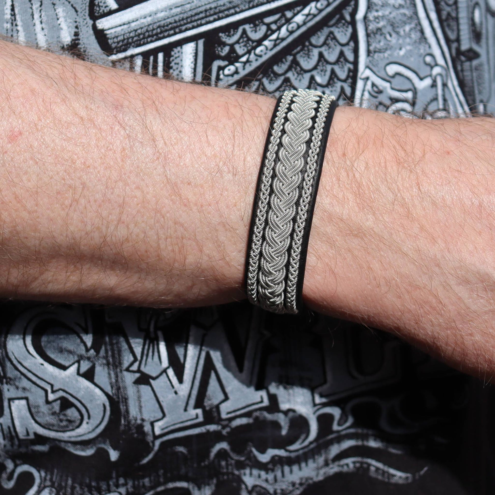 Close-up of Sami leather bracelet with pewter braids worn on wrist